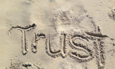 Trust in God written in the sand